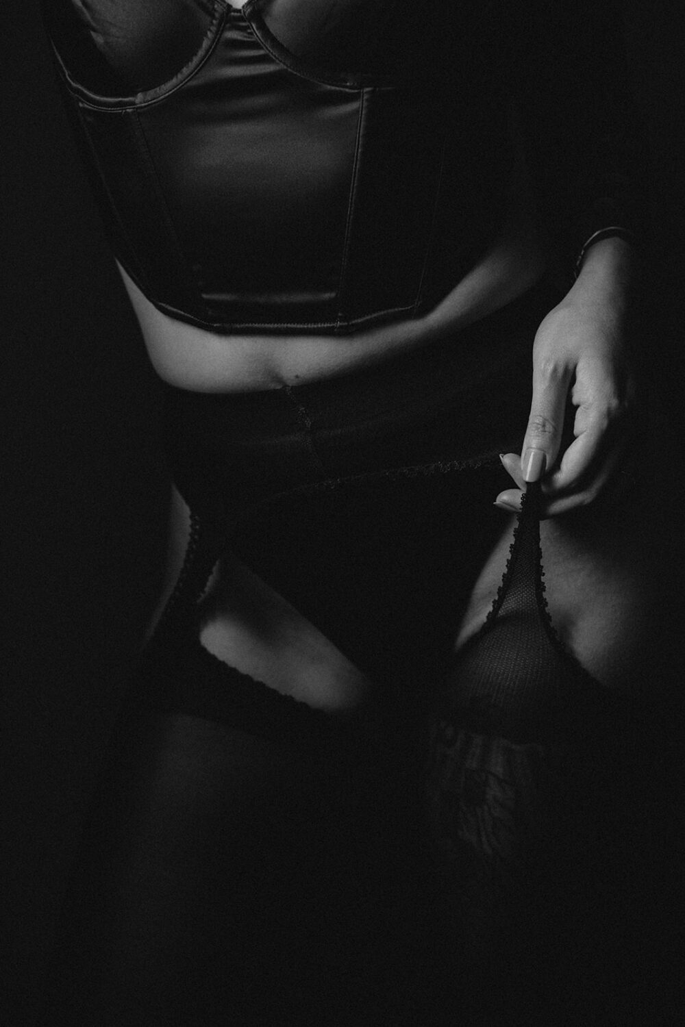 woman grabs lingerie at boudoir session