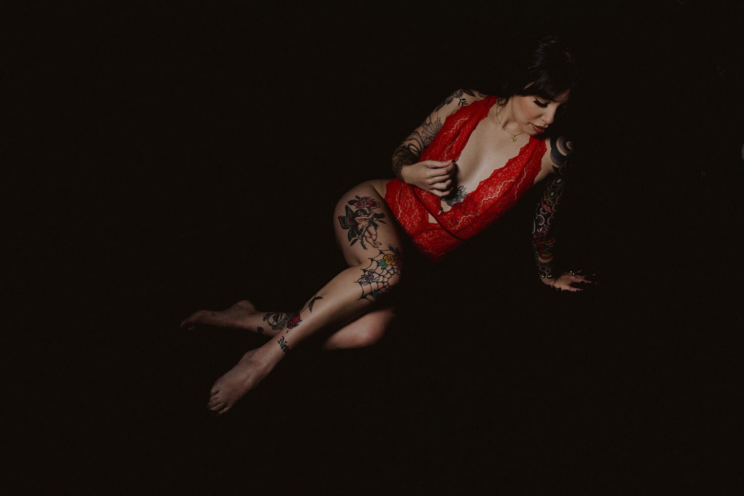 woman in lingerie with tattoos poses in boudoir session